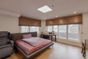 따뜻한 우드톤이 감싸는 모던 펜트하우스 침실